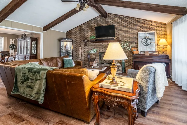 a living room with furniture a fireplace and a flat screen tv