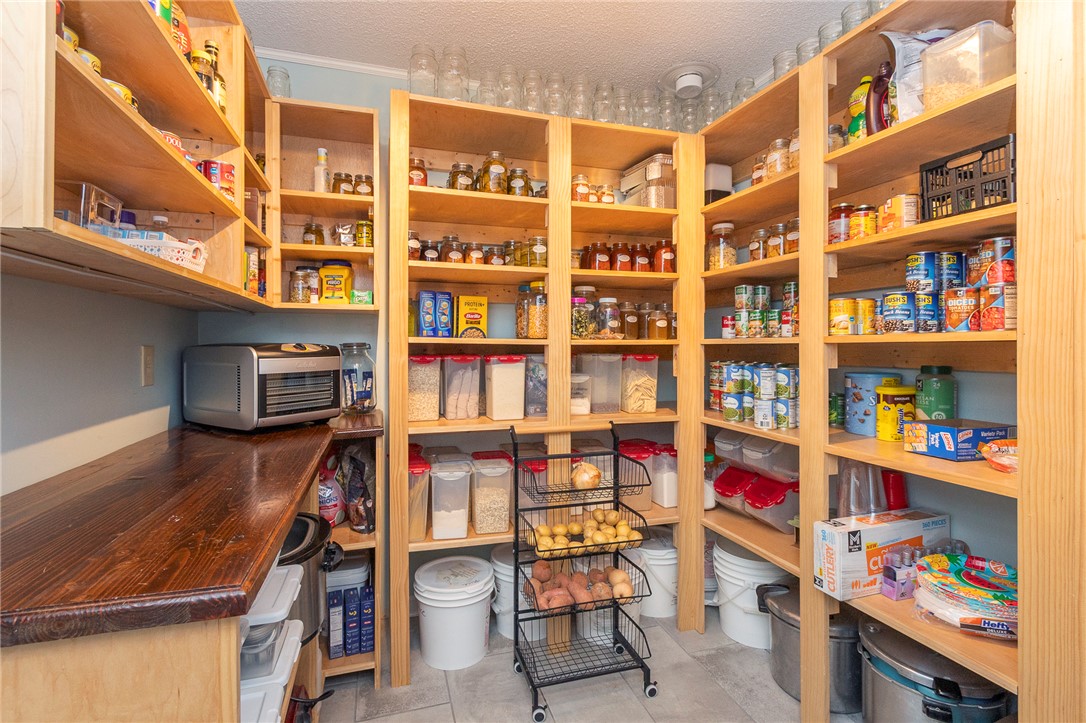 203 Oak Hollow Pendleton, SC 29670 - Photo 18 of 50 Discover a well-organized pantry featuring ample custom-built shelving and a rich wooden countertop for effortless meal prep.