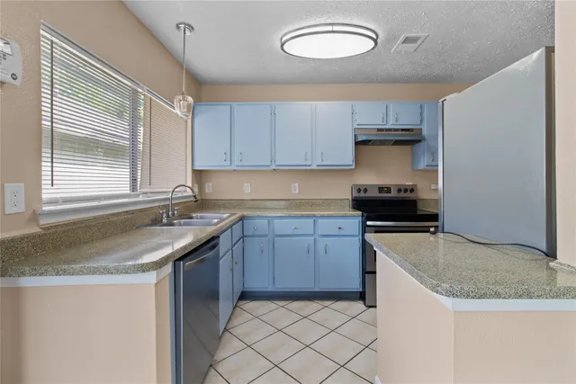a kitchen with granite countertop cabinets sink and a granite counter tops