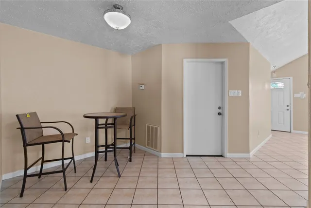 a view of a room with furniture and wooden floor