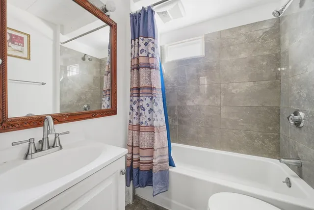 a bathroom with a sink a toilet and a bathtub