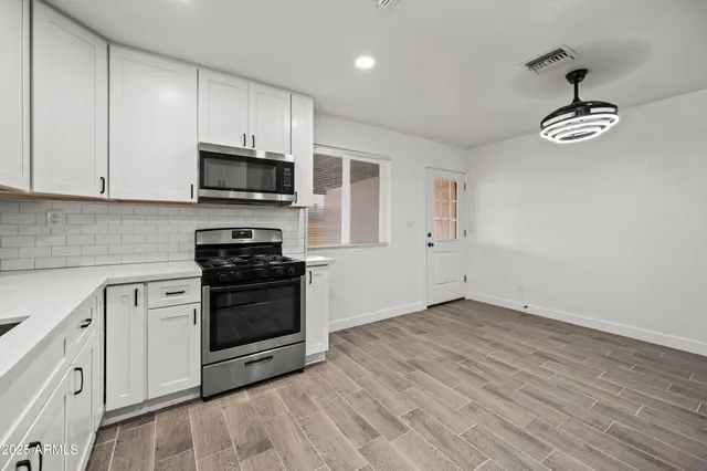 a kitchen with a stove and a microwave