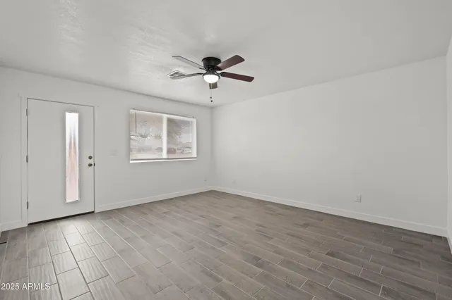 wooden floor in an empty room with a window