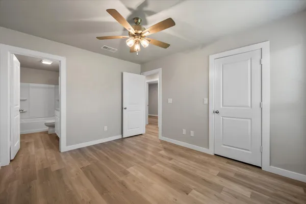 a view of an empty room and wooden floor