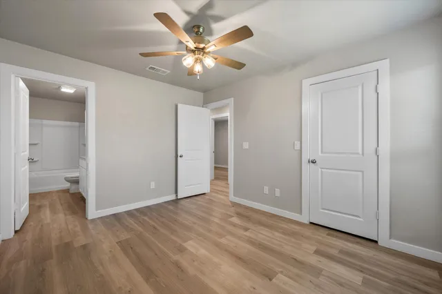 a view of an empty room and wooden floor