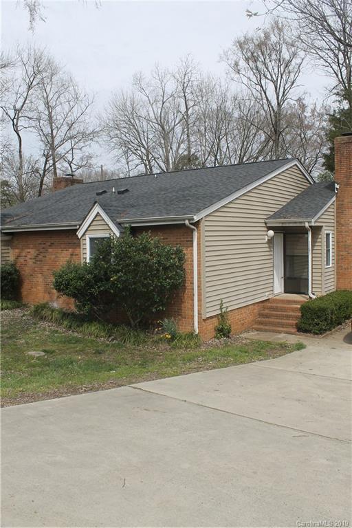 11203 Johnston Road Charlotte, NC 28226 - Photo 1 of 17 a backyard of a house with large trees and barbeque oven