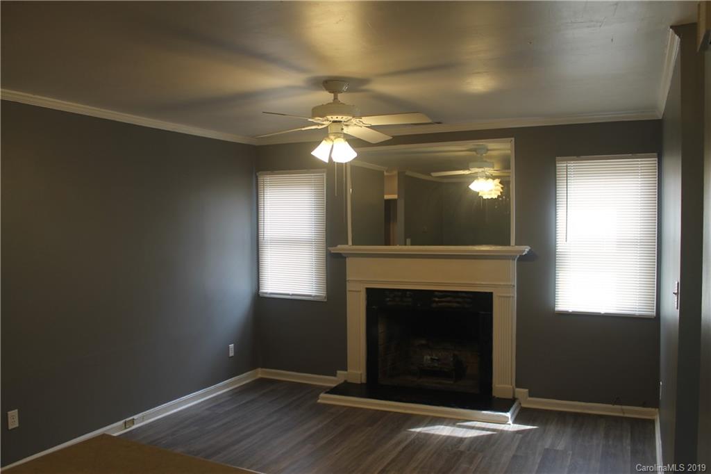 11203 Johnston Road Charlotte, NC 28226 - Photo 2 of 17 a view of a livingroom with a fireplace and a window