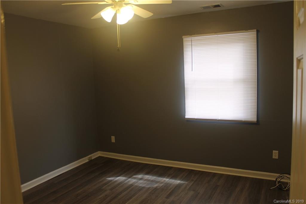 11203 Johnston Road Charlotte, NC 28226 - Photo 11 of 17 a view of a small space with wooden floor and a window