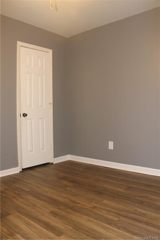 11203 Johnston Road Charlotte, NC 28226 - Photo 12 of 17 a view of an empty room with wooden floor