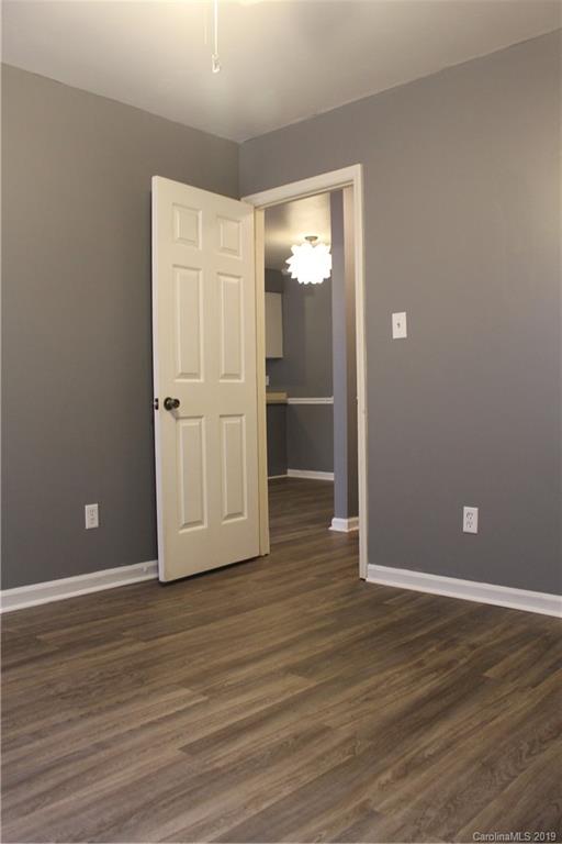 11203 Johnston Road Charlotte, NC 28226 - Photo 13 of 17 a view of an empty room with wooden floor and closet