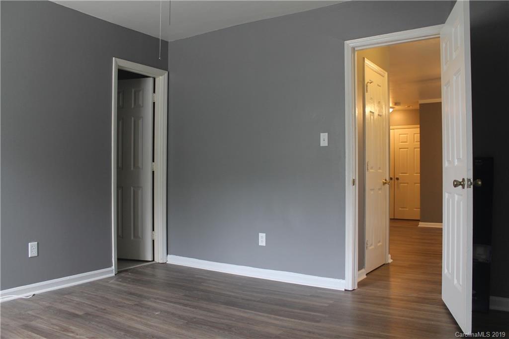 11203 Johnston Road Charlotte, NC 28226 - Photo 15 of 17 an empty room and wooden floor