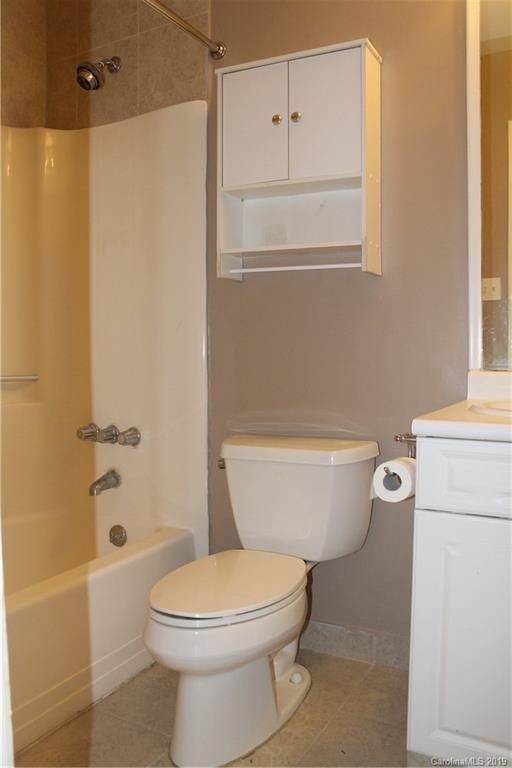 11203 Johnston Road Charlotte, NC 28226 - Photo 16 of 17 a white toilet sitting next to a bath tub