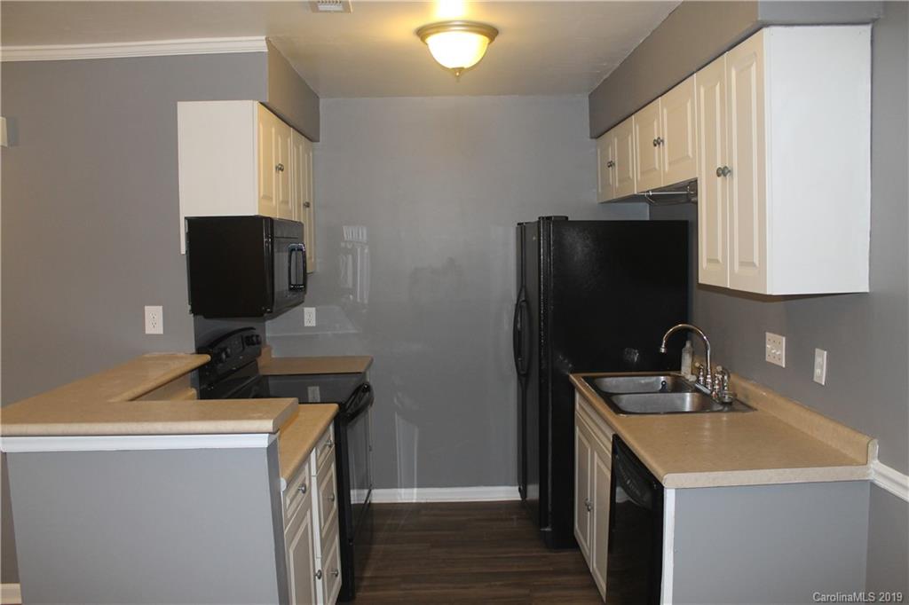 11203 Johnston Road Charlotte, NC 28226 - Photo 7 of 17 a kitchen with a sink and a refrigerator