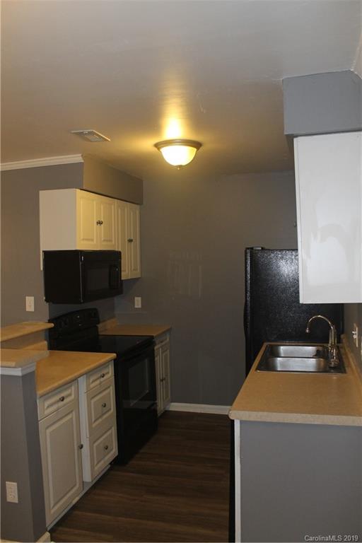11203 Johnston Road Charlotte, NC 28226 - Photo 8 of 17 a kitchen with a sink and a microwave