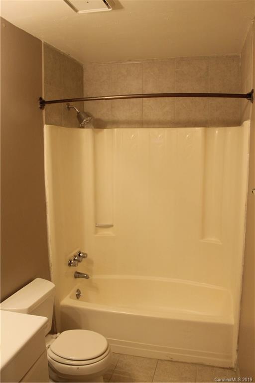 11203 Johnston Road Charlotte, NC 28226 - Photo 10 of 17 a bathroom with a toilet and a shower