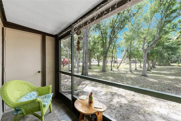 a view of a chairs and table in backyard of a house