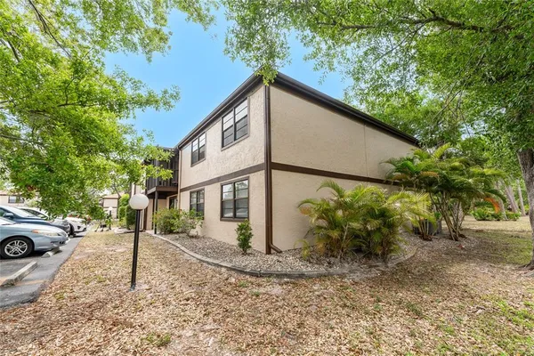 a view of a house with large space and a tree