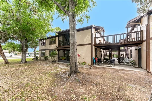 a view of a house with a yard and tree
