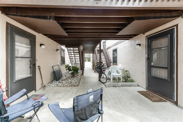 a view of a porch with chairs and backyard