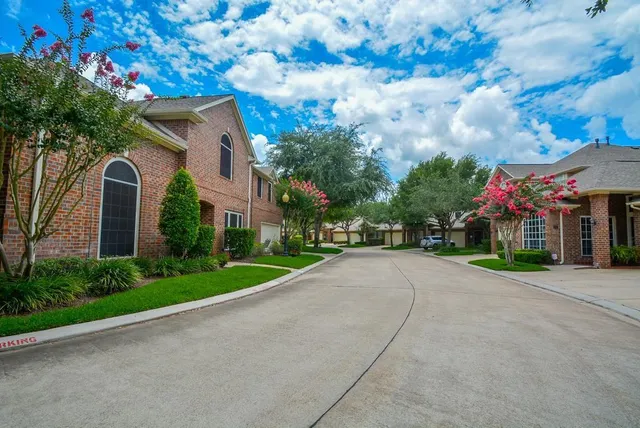 a front view of a house with a yard and a garage