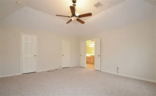 a view of a room with a ceiling fan