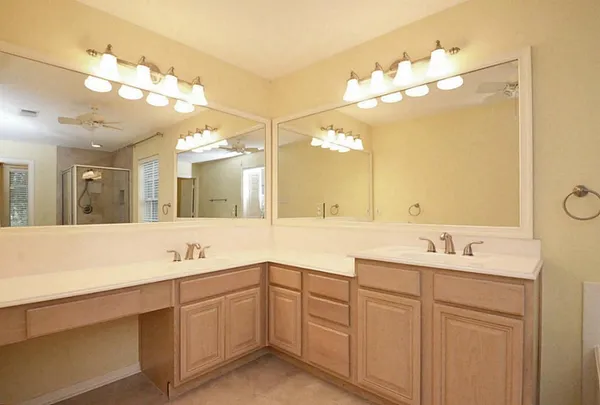 a bathroom with a sink vanity and mirror
