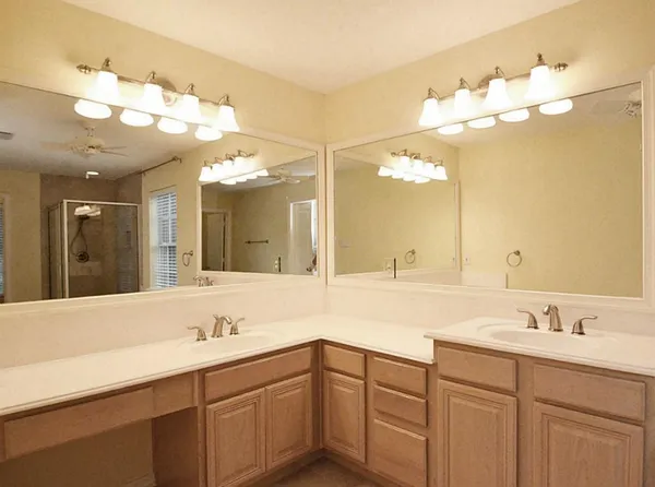 a bathroom with a sink vanity and mirror