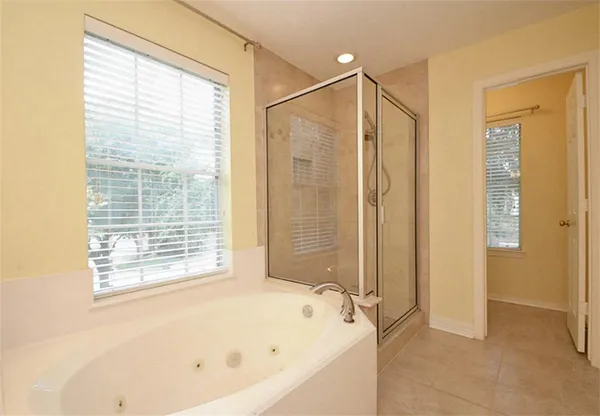 a bathroom with a bathtub and a shower