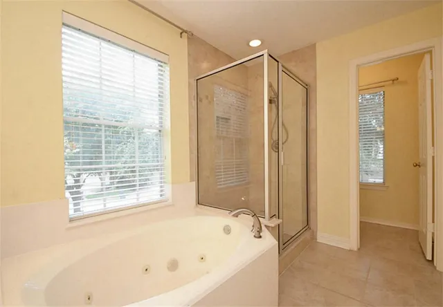 a bathroom with a bathtub and a shower