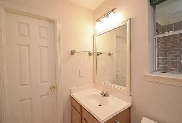 a bathroom with a sink a mirror and a shower