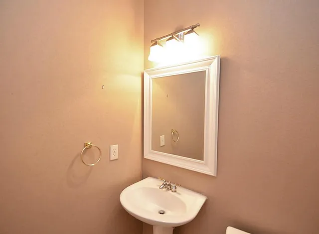 a bathroom with a sink a mirror and a vanity