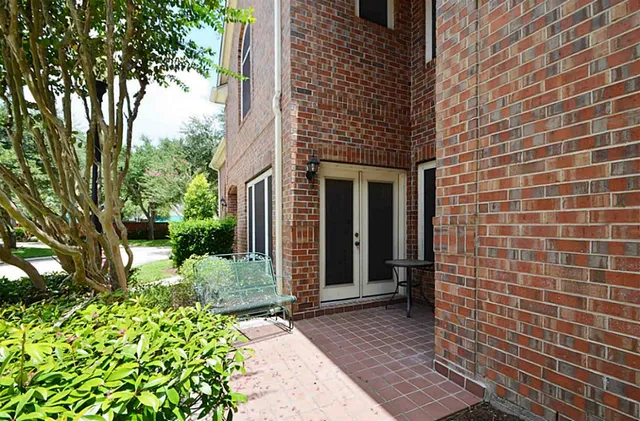 a pathway of a house with a yard