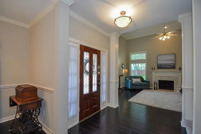 a living room with furniture a fireplace and a mirror