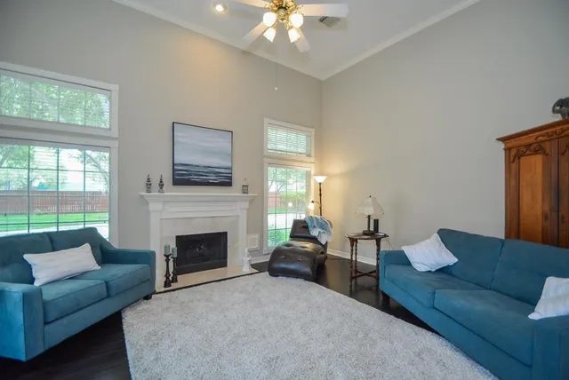 a living room with furniture and a fireplace