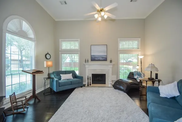 a living room with furniture fireplace and a large window