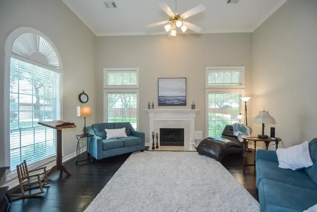a living room with furniture fireplace and a large window