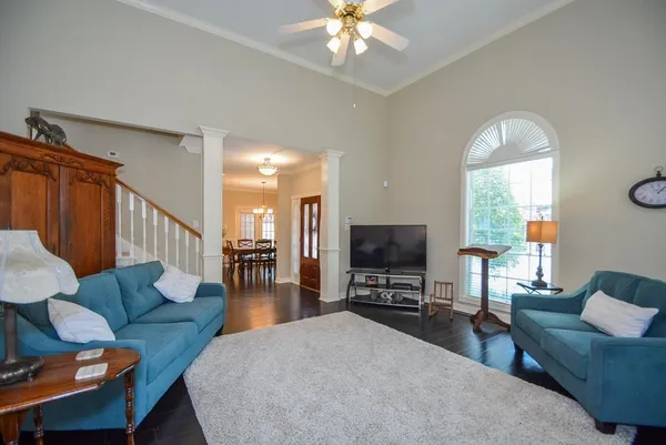 a living room with furniture a fireplace and a flat screen tv