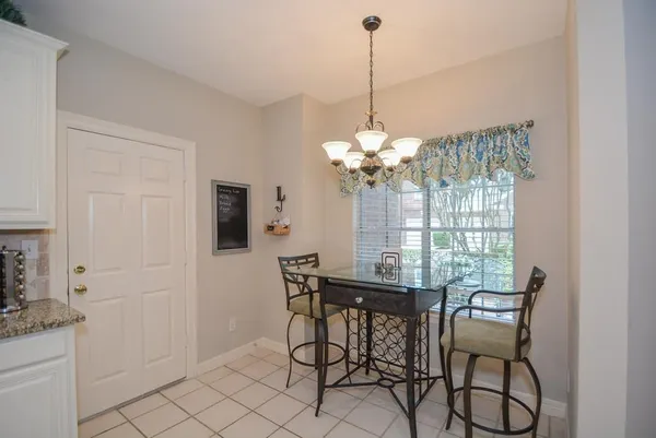 a view of a dining room with furniture and chandelier
