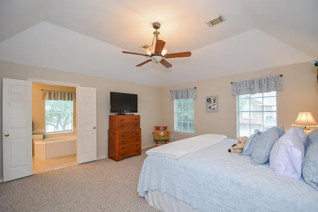 a bedroom with a balcony a bed and a chandelier