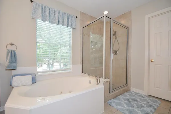 a bathroom with a bathtub and a shower