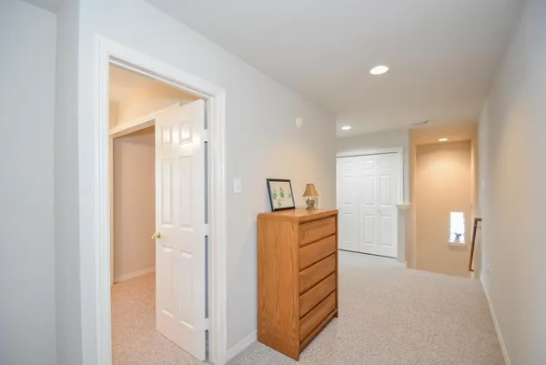 a view of hallway with wooden floor