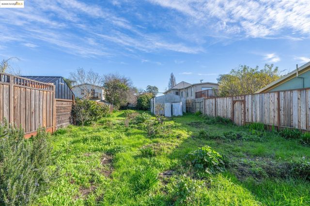 a view of a house with a backyard and a garden