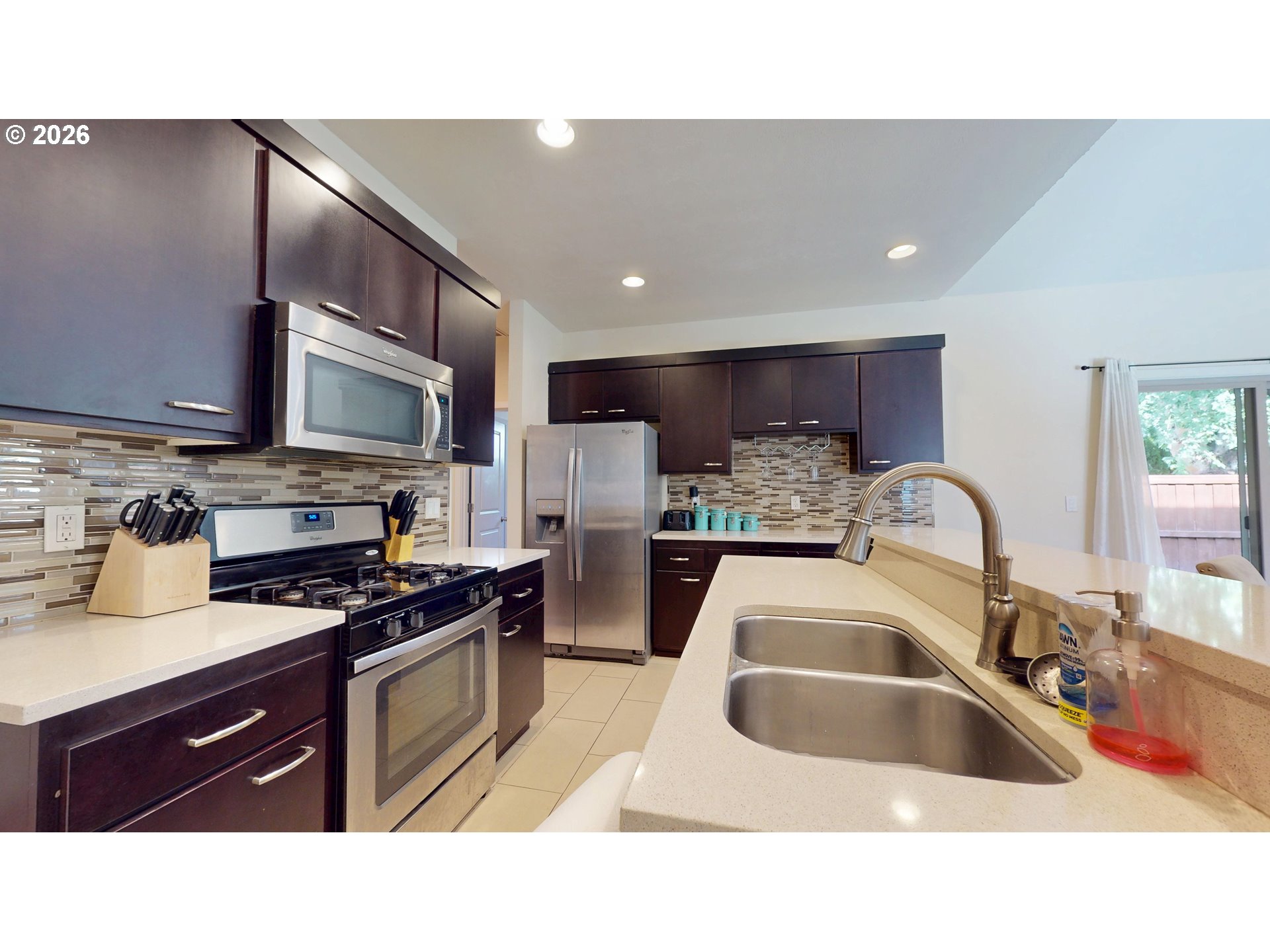 375 Mia Lane Eugene, OR 97401 - Photo 12 of 44 a kitchen with stainless steel appliances granite countertop a sink stove and refrigerator