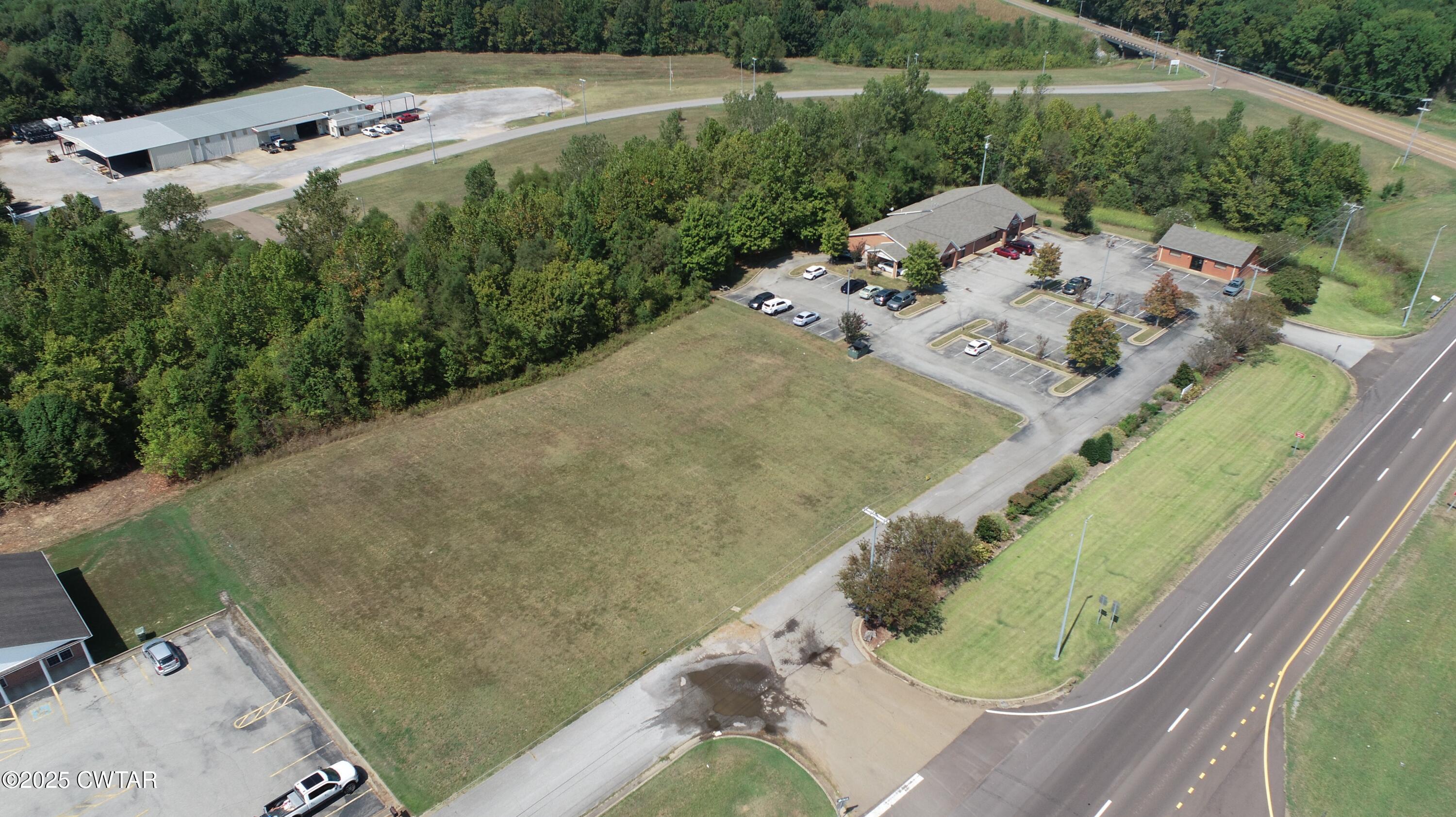 0 U S 51 Street South Ripley, TN 38063 - Photo 1 of 3 an aerial view of a house a yard and lake