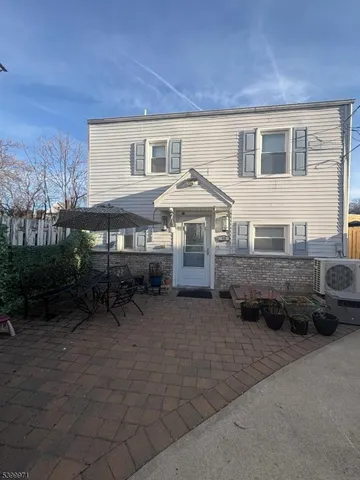 a front view of a house with yard and seating space