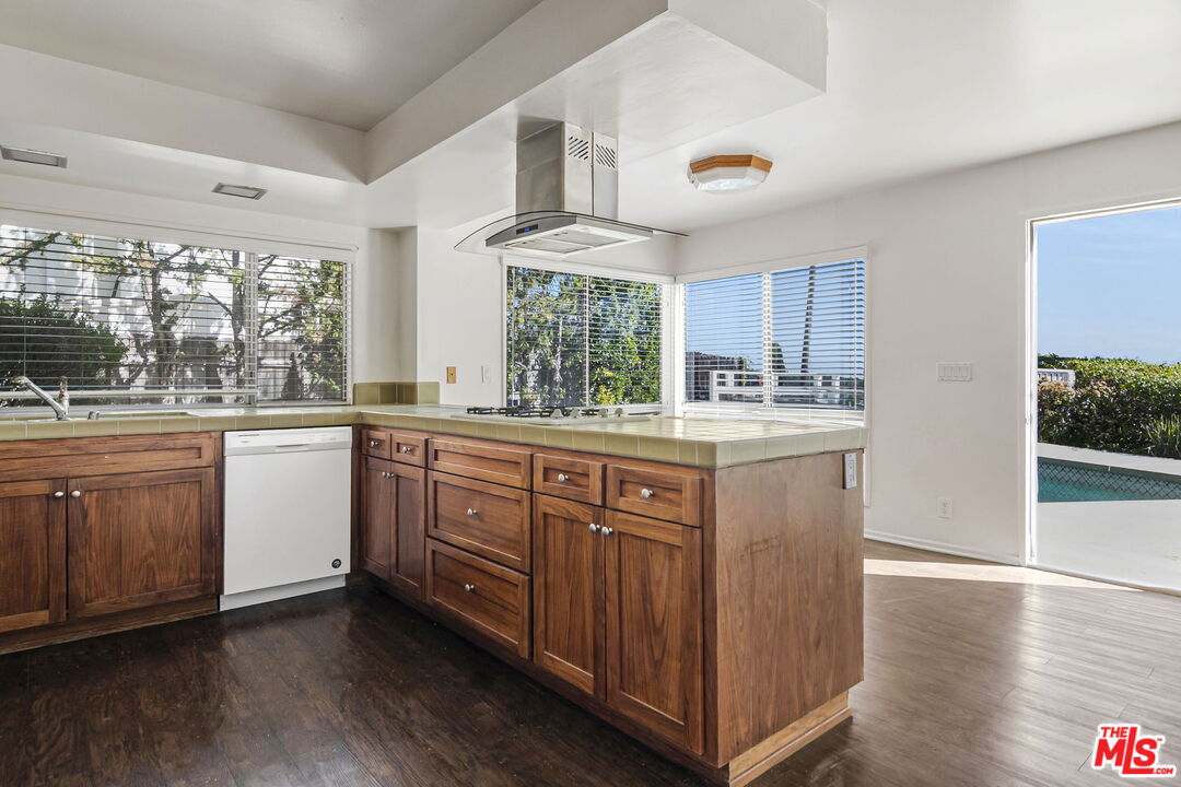 2695 Cordelia Road Los Angeles, CA 90049 - Photo 12 of 33 a kitchen with a sink cabinets wooden floor and stainless steel appliances