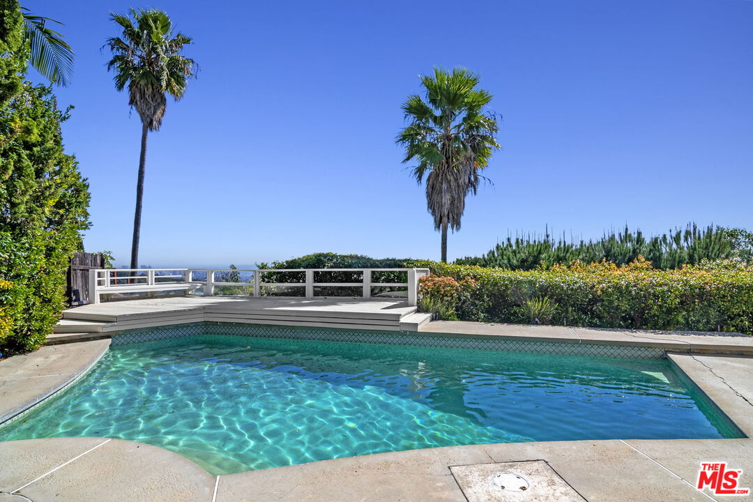 2695 Cordelia Road Los Angeles, CA 90049 - Photo 14 of 33 a view of a swimming pool with a yard