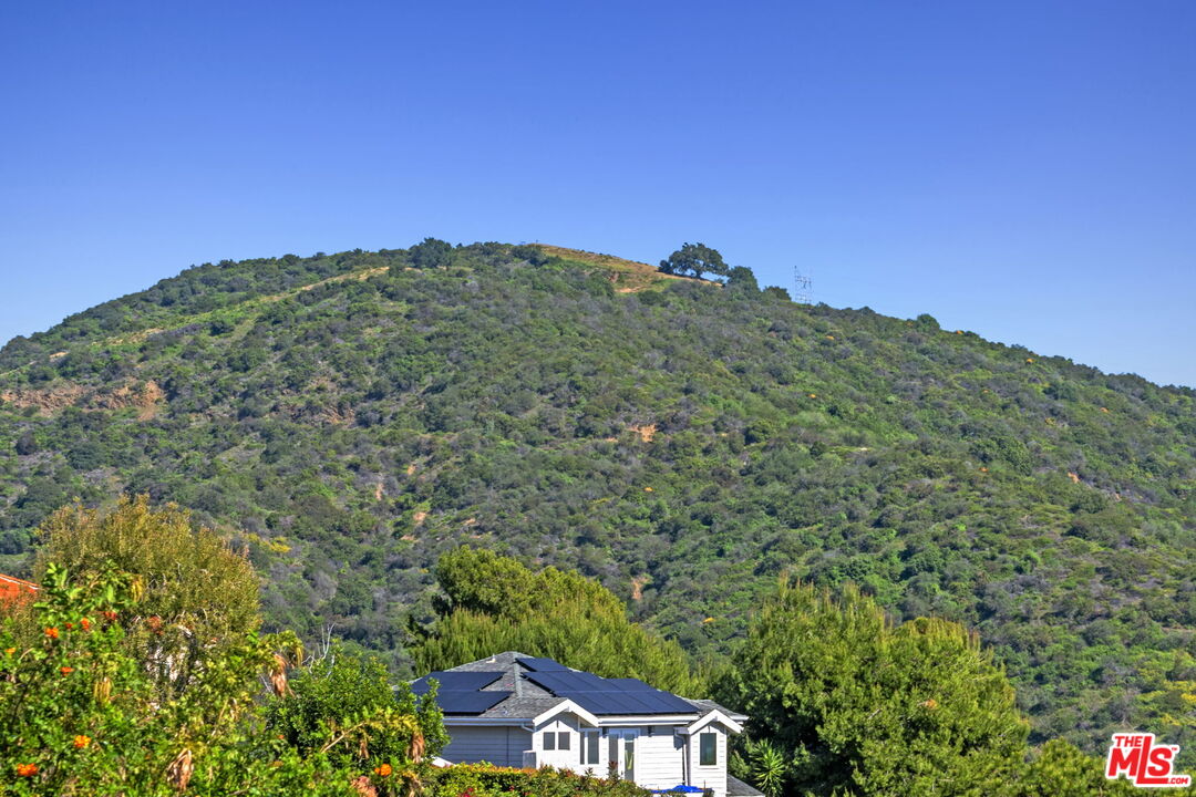 2695 Cordelia Road Los Angeles, CA 90049 - Photo 17 of 33 a view of a large building with a mountain in the background