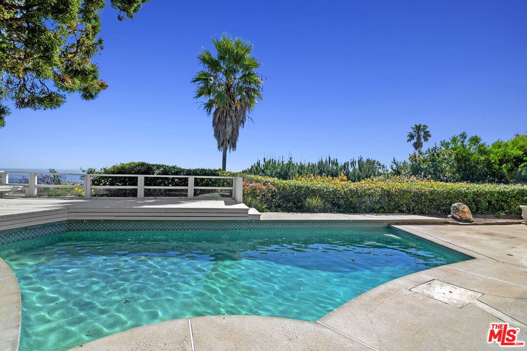 2695 Cordelia Road Los Angeles, CA 90049 - Photo 20 of 33 a view of a swimming pool with a yard