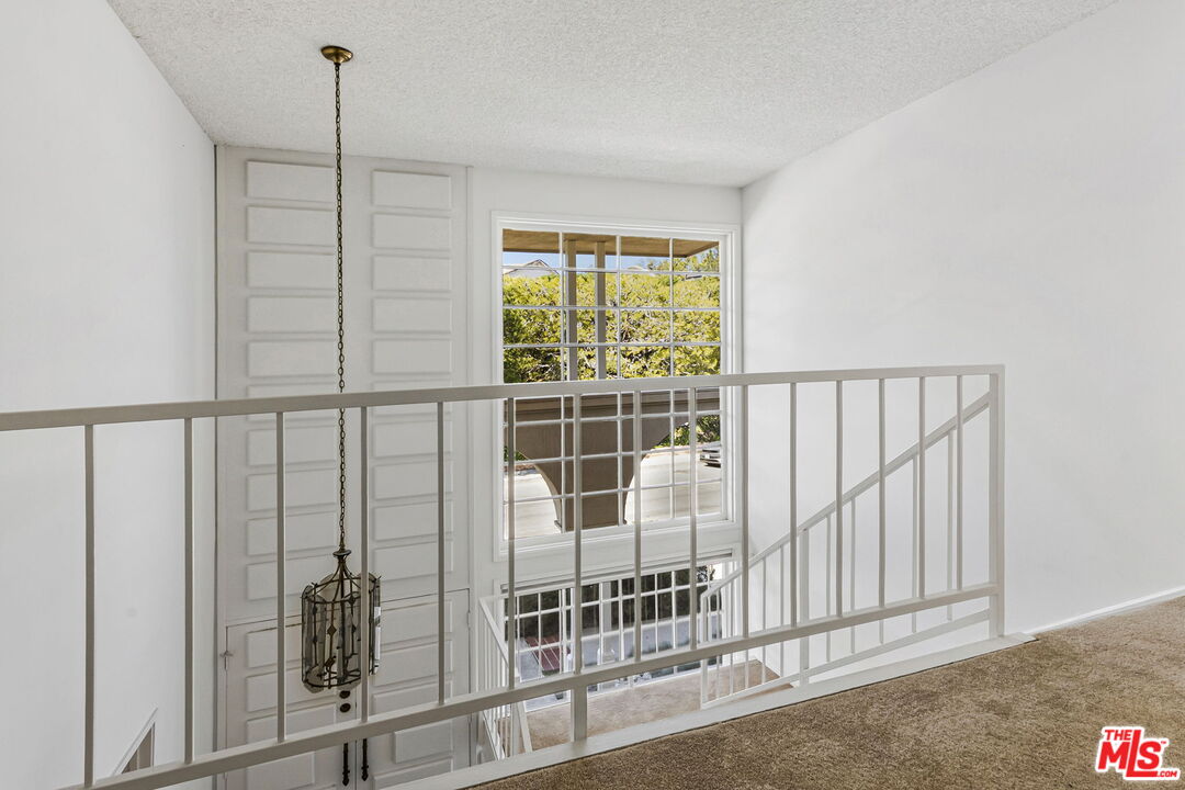 2695 Cordelia Road Los Angeles, CA 90049 - Photo 22 of 33 a view of a balcony with wooden floor and fence